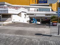 a white building that has a sign at the top of it with a small car