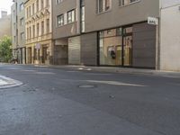 a couple of cars are on the side of a road near some buildings in europe