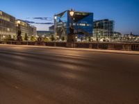 the city skyline is at night from the street level with traffic and pedestrians walking on it