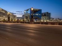 the city skyline is at night from the street level with traffic and pedestrians walking on it