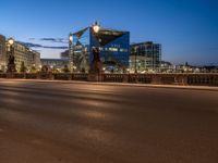 the city skyline is at night from the street level with traffic and pedestrians walking on it