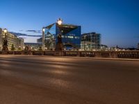 the city skyline is at night from the street level with traffic and pedestrians walking on it