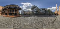 two buildings are seen in a fisheye view as they look like they're in a series of mirrors