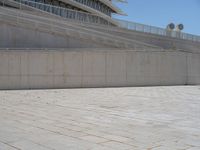 a black fire hydrant is sitting in the concrete area in front of a large building