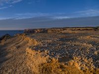 a lone lighthouse is perched on the edge of a cliff in front of the ocean