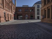 this old city street has cobblestone on it in the evening sun to highlight its surroundings