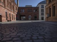 this old city street has cobblestone on it in the evening sun to highlight its surroundings