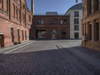 this old city street has cobblestone on it in the evening sun to highlight its surroundings