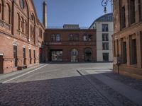 this old city street has cobblestone on it in the evening sun to highlight its surroundings