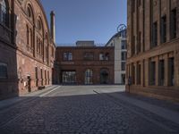 this old city street has cobblestone on it in the evening sun to highlight its surroundings