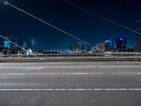 an evening view shows a city and its light trails down the street, with a bike lane to the left