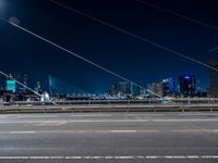 an evening view shows a city and its light trails down the street, with a bike lane to the left