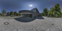 360 - vision image of the exterior of a museum, with bikes parked in the driveway