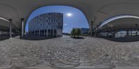 the reflection in the fisheye lens is clearly visible from the circular walkway with a person walking across