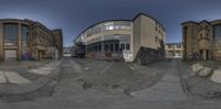 a fish - eye view of a street and buildings in a city, taken with a fisheye lens