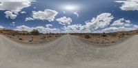 360 - pano shot of a gravel road with clouds in the sky above it