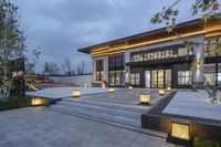 the exterior of a house, lit at night by led lightings, includes several steps leading to a deck