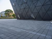 this is an exterior shot of a building with geometric, shaped shapes on it's surface