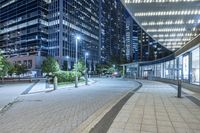 city view at night with lights in buildings, walkways and street lights near buildings