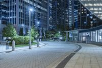 city view at night with lights in buildings, walkways and street lights near buildings