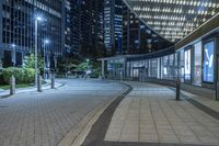 city view at night with lights in buildings, walkways and street lights near buildings