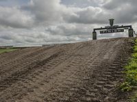 the dirt is being removed near a farm in rural countryside, with a sign warning that tractor tracks are not in place