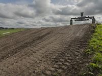 the dirt is being removed near a farm in rural countryside, with a sign warning that tractor tracks are not in place