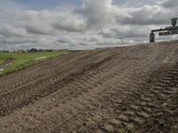 the dirt is being removed near a farm in rural countryside, with a sign warning that tractor tracks are not in place