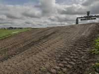 the dirt is being removed near a farm in rural countryside, with a sign warning that tractor tracks are not in place