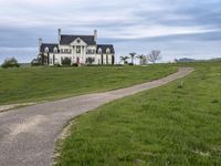 an image of a farm house and walkway in the country side view, just in the middle of the day