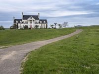 an image of a farm house and walkway in the country side view, just in the middle of the day