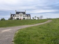 an image of a farm house and walkway in the country side view, just in the middle of the day