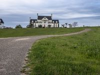 an image of a farm house and walkway in the country side view, just in the middle of the day