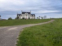 an image of a farm house and walkway in the country side view, just in the middle of the day