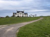 an image of a farm house and walkway in the country side view, just in the middle of the day