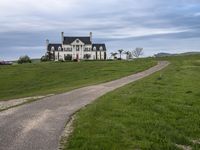 an image of a farm house and walkway in the country side view, just in the middle of the day