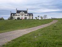 an image of a farm house and walkway in the country side view, just in the middle of the day