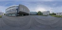 a view of a modern building from the outside with an inverted circular roof in front