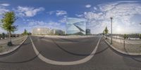 this is a distorted panorama photo of an asphalt street near the city hall of stockholm