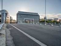 the street next to the building is empty in this picture with no one at sight