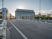 the street next to the building is empty in this picture with no one at sight