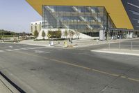 the large glass building has a yellow covering on the front of it's walls