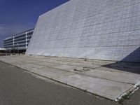 a white building with a roof and windows sits in a quiet area outside the buildings