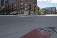 a fire hydrant sitting on top of a sidewalk next to tall buildings on a sunny day