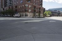 a fire hydrant sitting on top of a sidewalk next to tall buildings on a sunny day