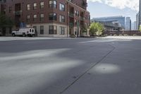 a fire hydrant sitting on top of a sidewalk next to tall buildings on a sunny day