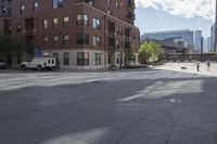 a fire hydrant sitting on top of a sidewalk next to tall buildings on a sunny day