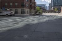 a fire hydrant sitting on top of a sidewalk next to tall buildings on a sunny day