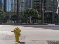 a yellow fire hydrant sitting on the side of a street near tall buildings and cars