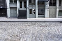 a fire hydrant sitting outside of a glass building with stairs next to it and a parking meter in front
